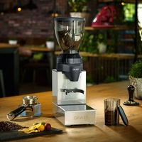 Kaffeemühle mit Zubehör auf einem Holztisch in einem Café