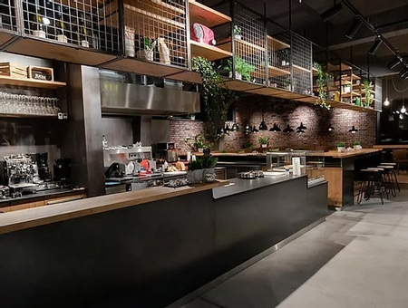 Interior of a cafe with counter, shelves and plants, modern design