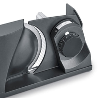 Gray electric food slicer with adjustment dial and blade for slicing food products.