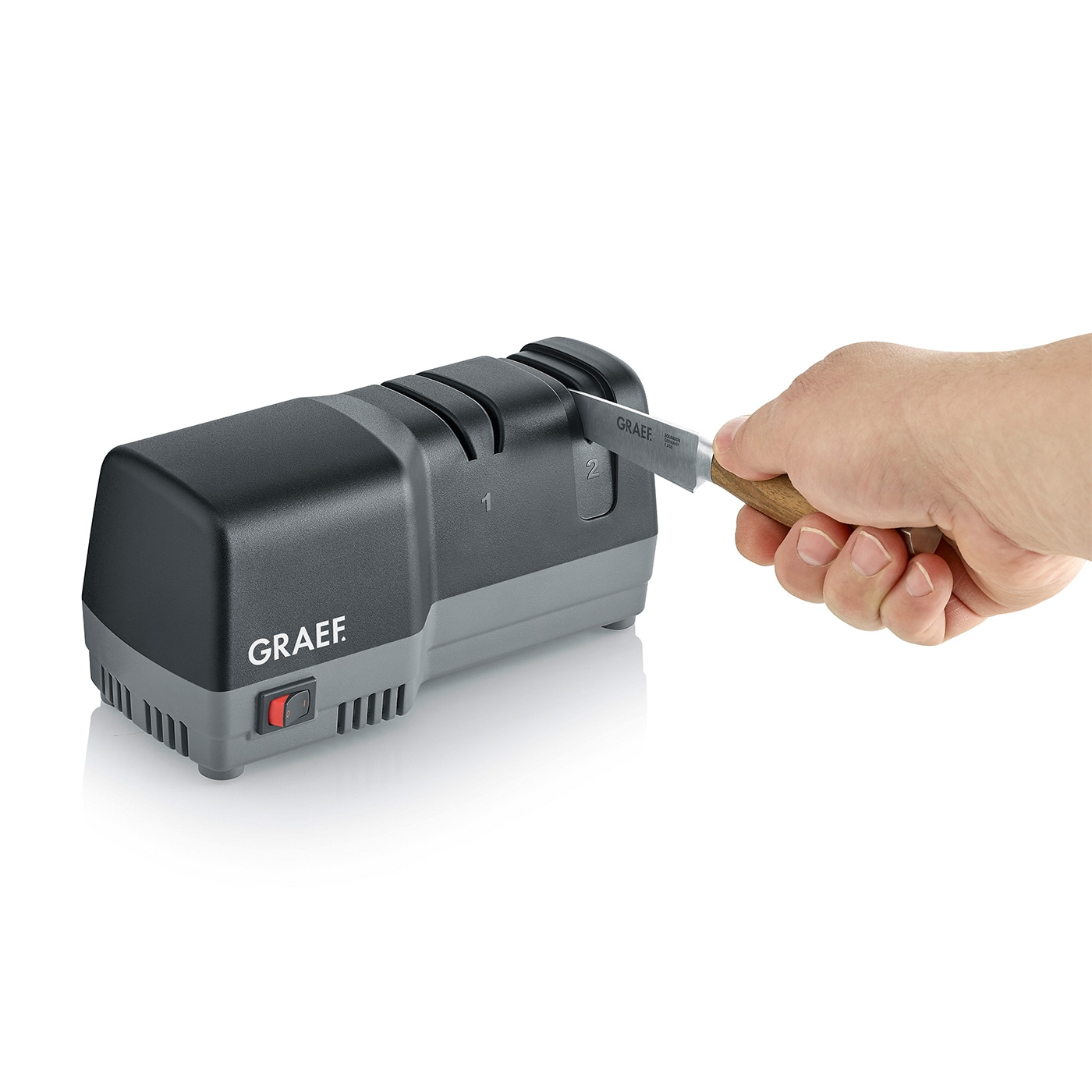 Graef Messerschärfer mit Messer und Hand, bereit zum Schärfen.