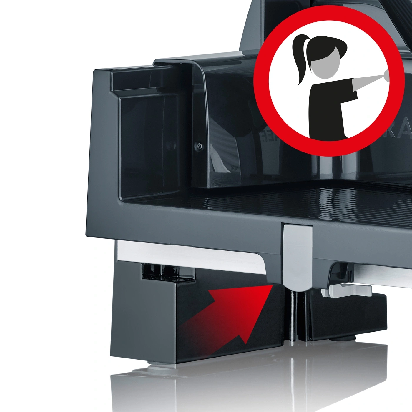 Close-up of an electric meat slicer with a warning sign and a red arrow pointing up.