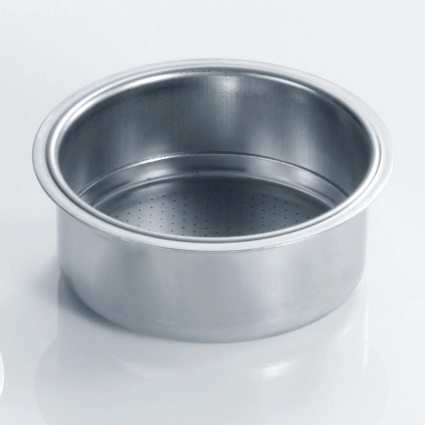 Stainless steel coffee filter, round, with holes, on white background, close-up