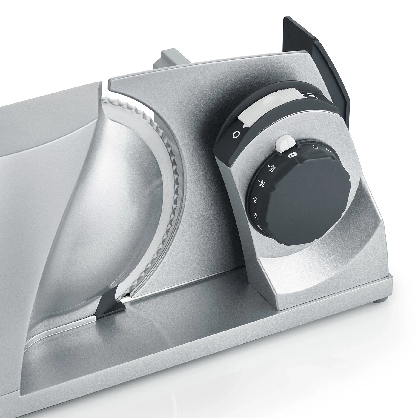 Close-up of a silver meat slicer with adjustment dial and blade.