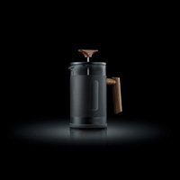 Coffee press with wooden handle and lid on a black background