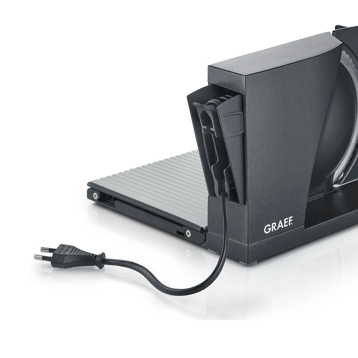 Close-up of a black Graef electric slicer with power cord and plug on white background