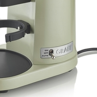 Coffee machine with switch and GRAEF logo, close-up, greenish color