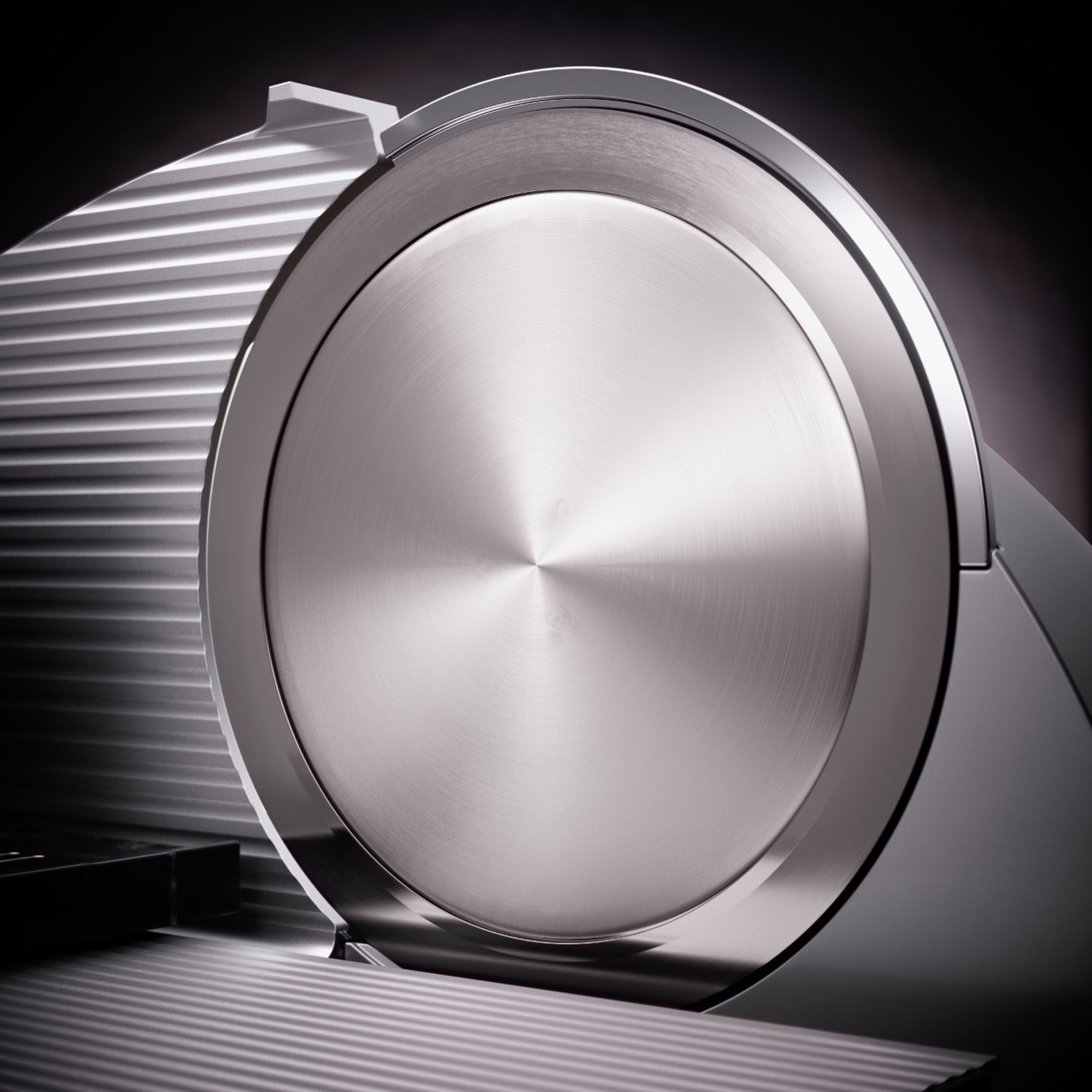 Close-up of a silver meat slicer with a shiny surface and intricate details