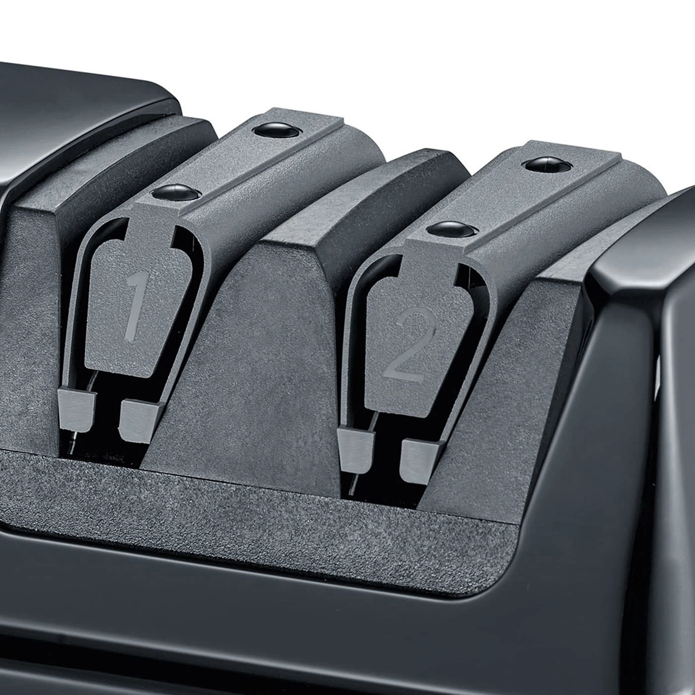Close-up of a black knife sharpener with the numbers 1 and 2 visible.
