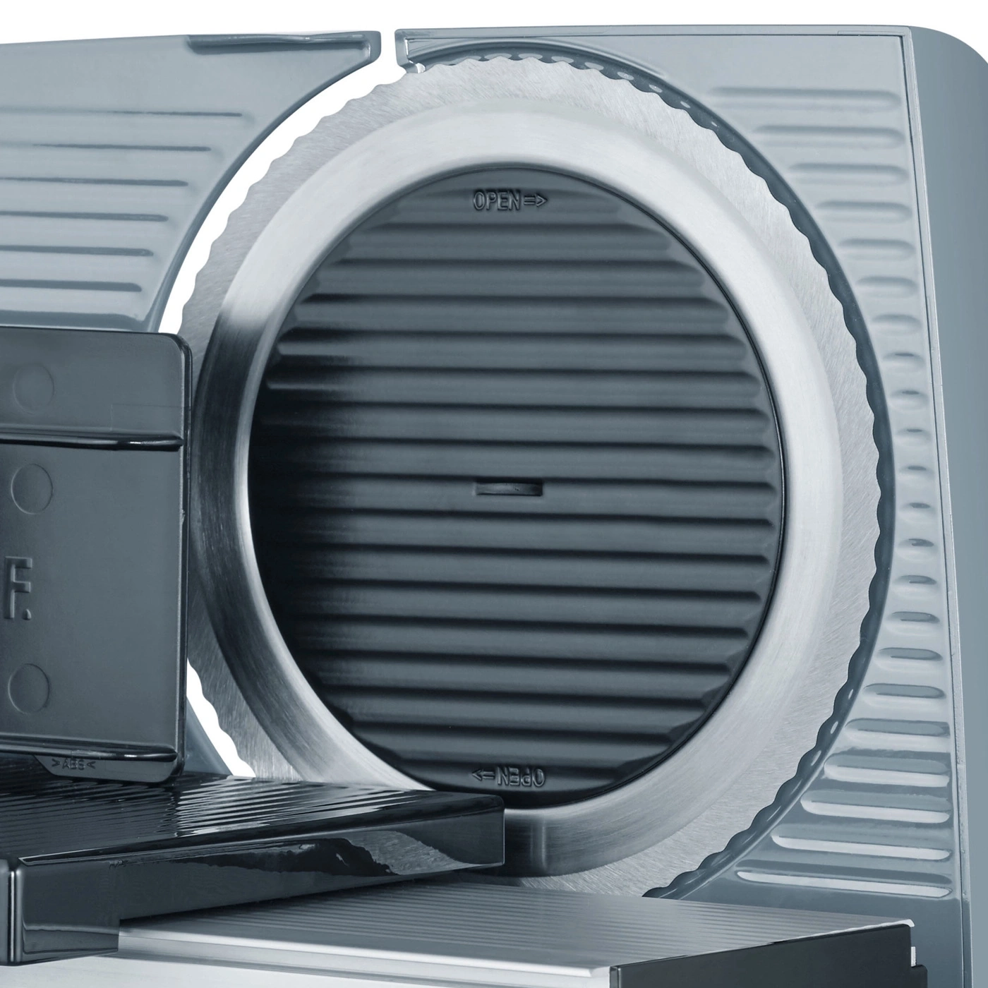 Close-up of an electric meat slicer showing the detailed blade and controls.