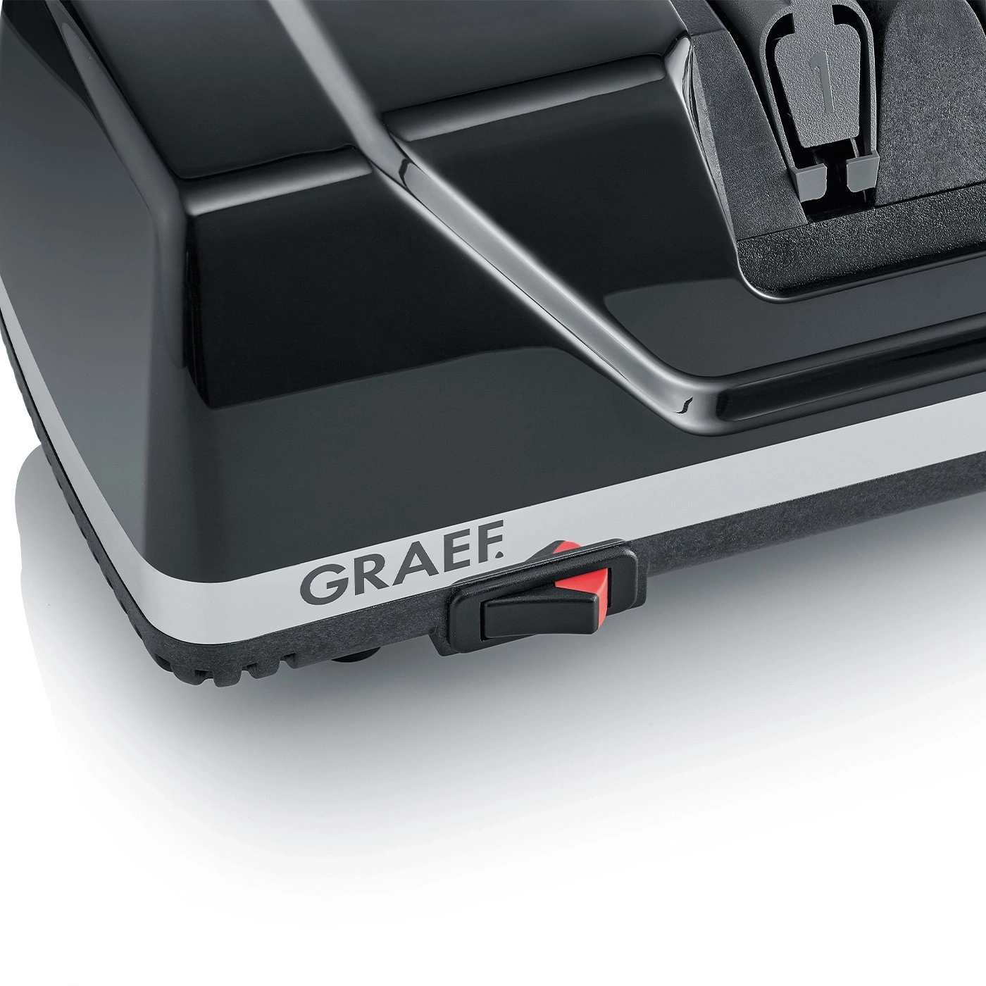 Black device with red switch and GRAEF logo on white background, close-up.
