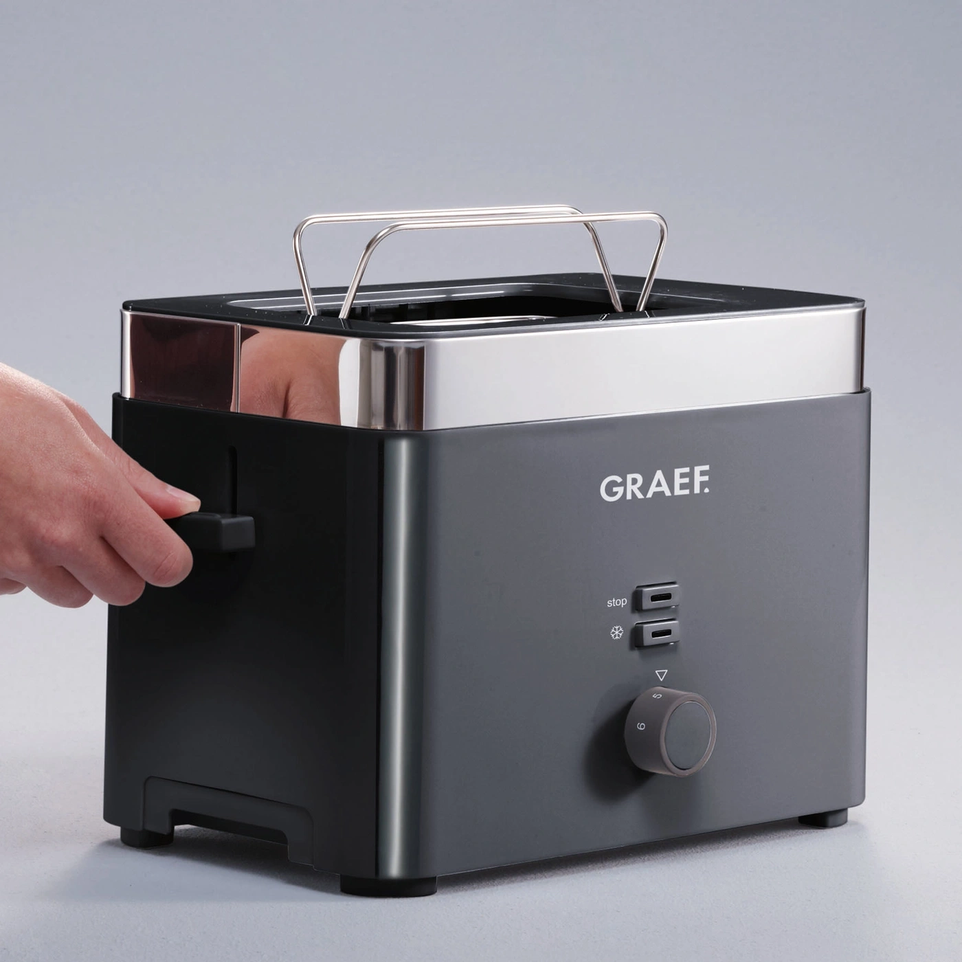 Black Graef toaster with lever and dial, perfect for toasting bread slices.