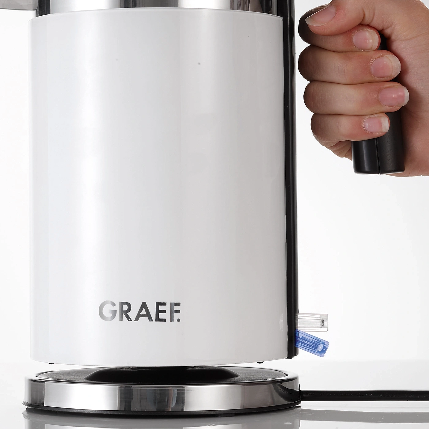 White kettle with handle and GRAEF logo on a white background, close-up.
