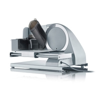 Graef Allesschneider, silberfarben, mit transparentem Kunststoffaufsatz und Kabel.