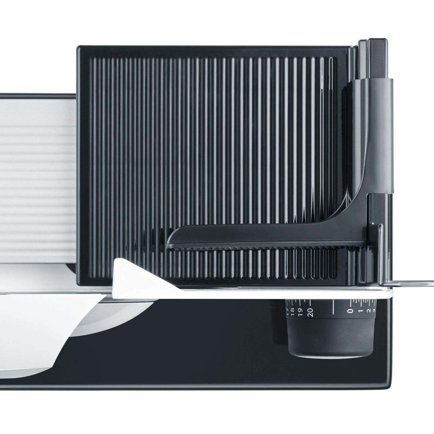 Close-up of an electric meat slicer showing ribbed texture and adjustment dial.