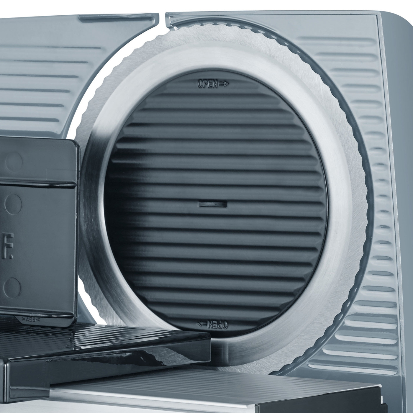 Close-up of an electric meat slicer showing the detailed blade and controls.