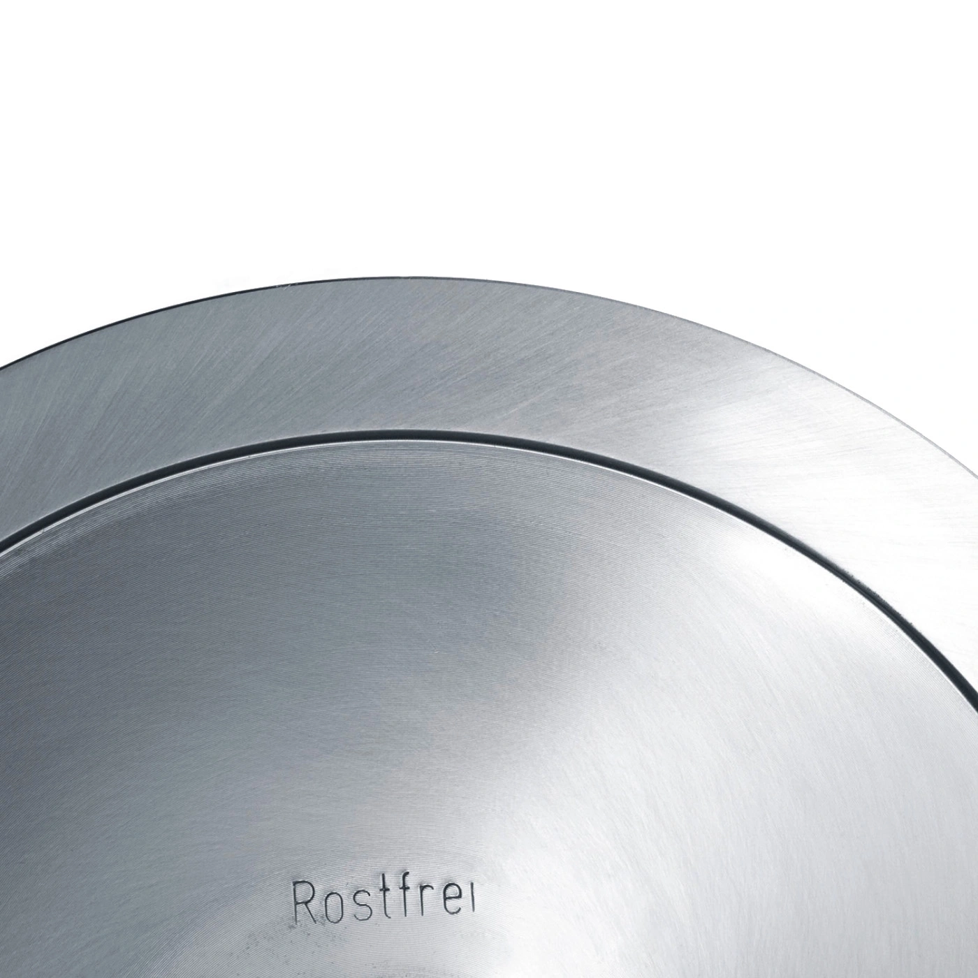 Close-up of a silver metal surface with the word Rostfrei engraved on it.