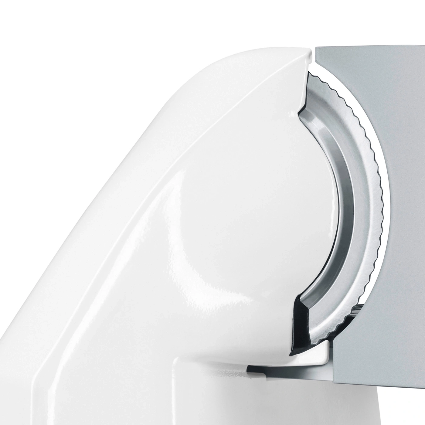 Close up of a white food slicer machine with a blade