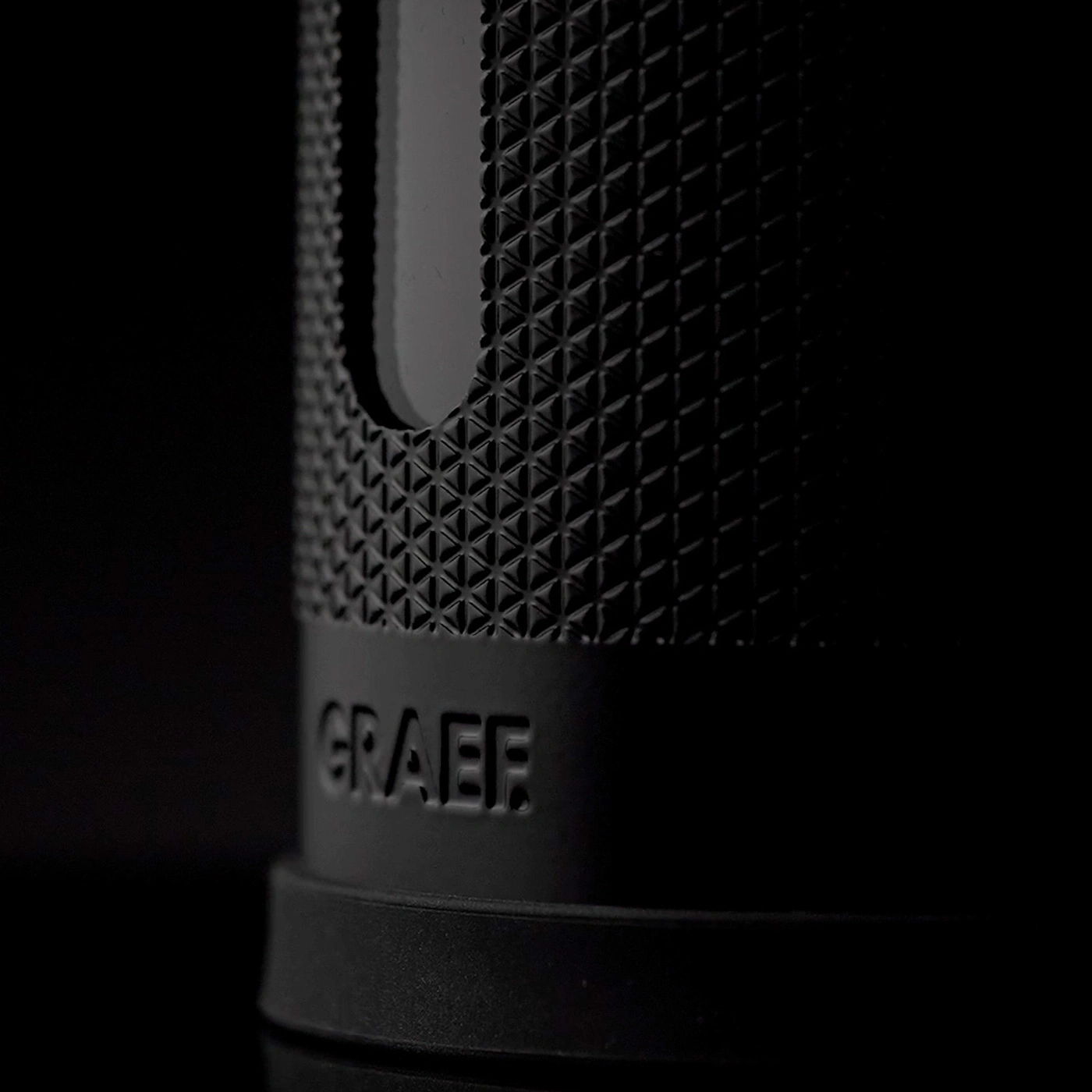 Close-up of a black device with the engraved name GRAEF.