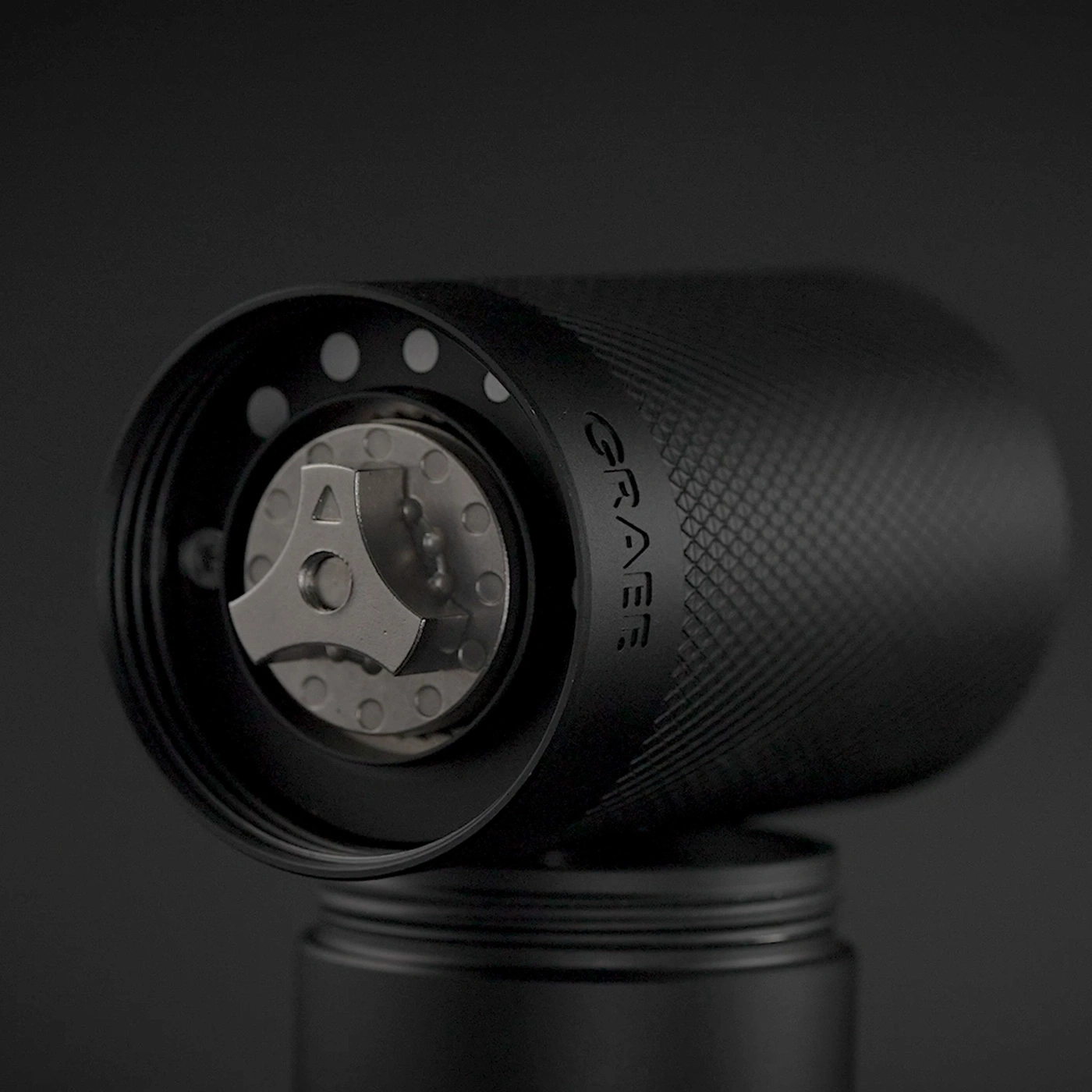 Black coffee grinder burr set with "GRAEF" logo on dark background.