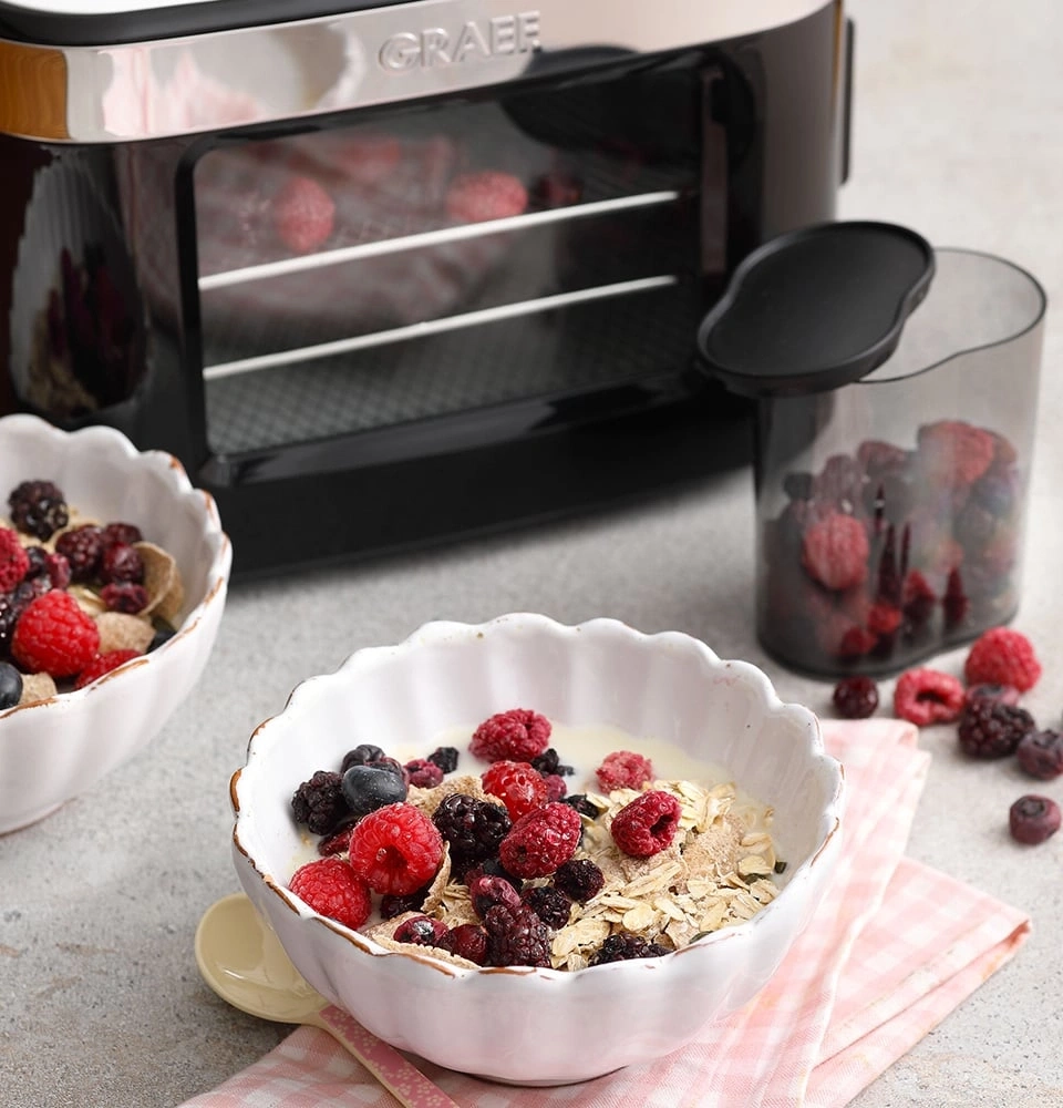 Breakfast with berries and cereal, oven in background, delicious food