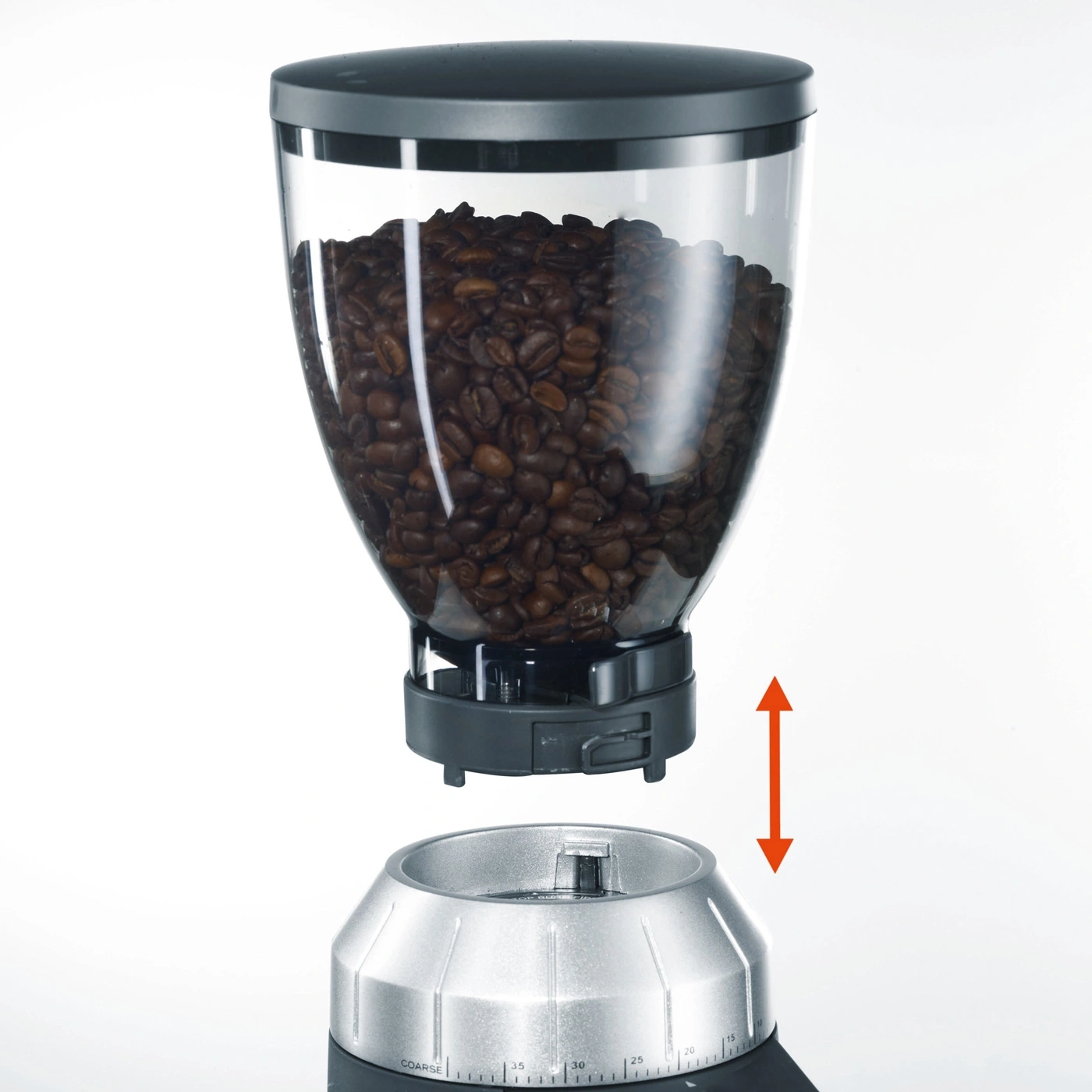 Coffee grinder with bean container, arrow indicates direction.