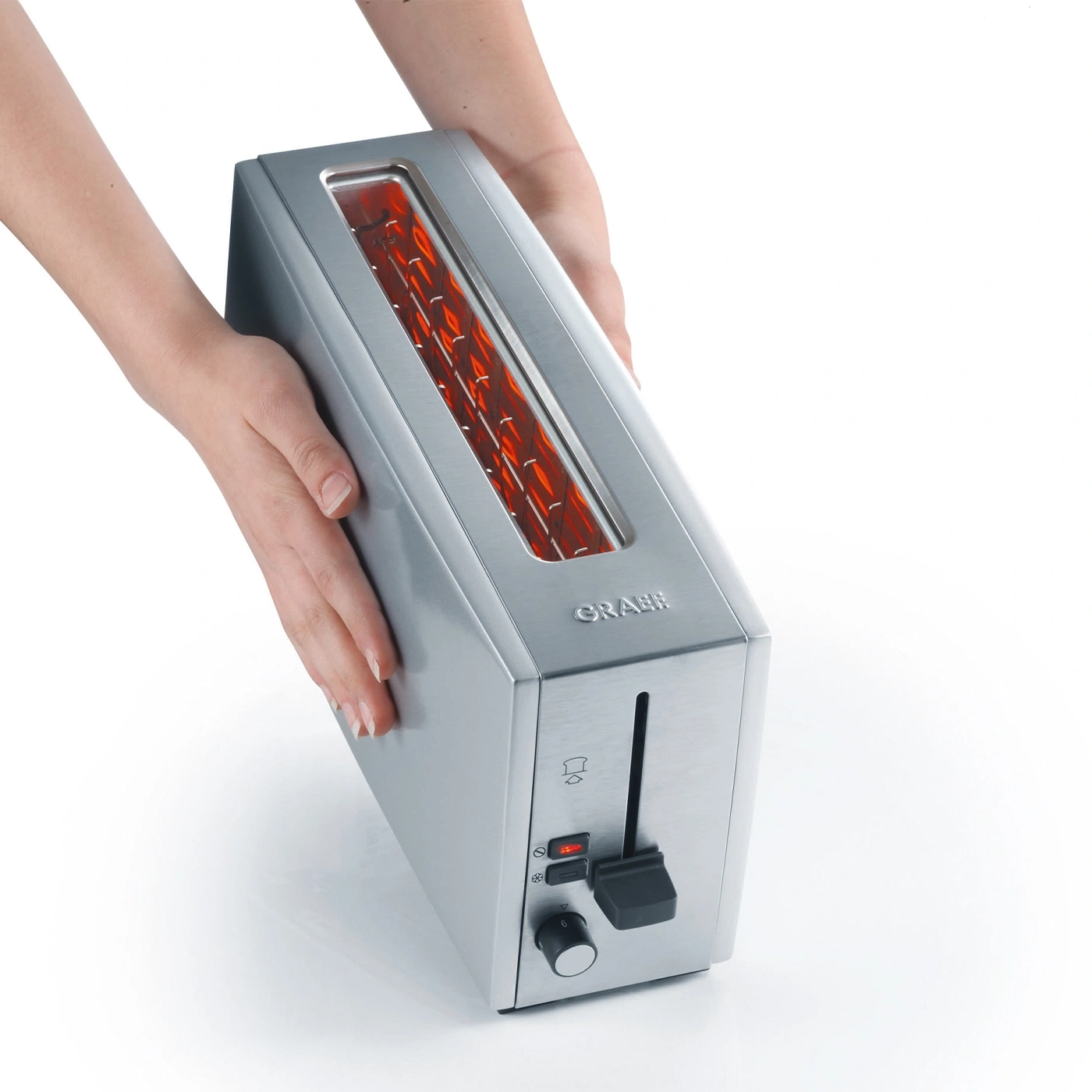 Silver toaster held by hands, red light inside, GRAEF logo, control panel, kitchen appliance