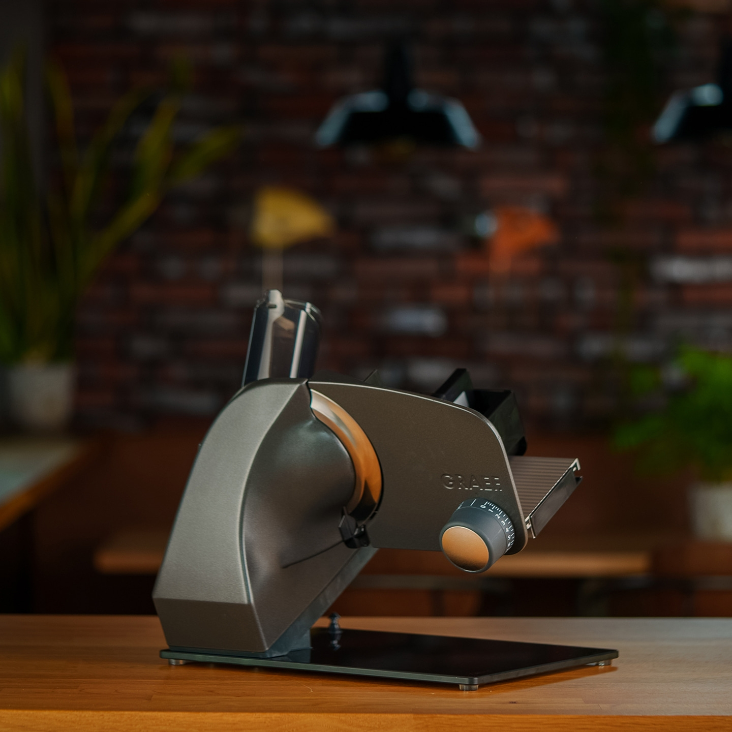 Graef slicer on wooden table, kitchen in background