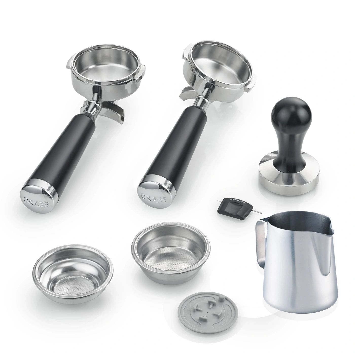 Coffee machine accessories: portafilters, tamper, milk jug, filters, cleaning pin, and more.