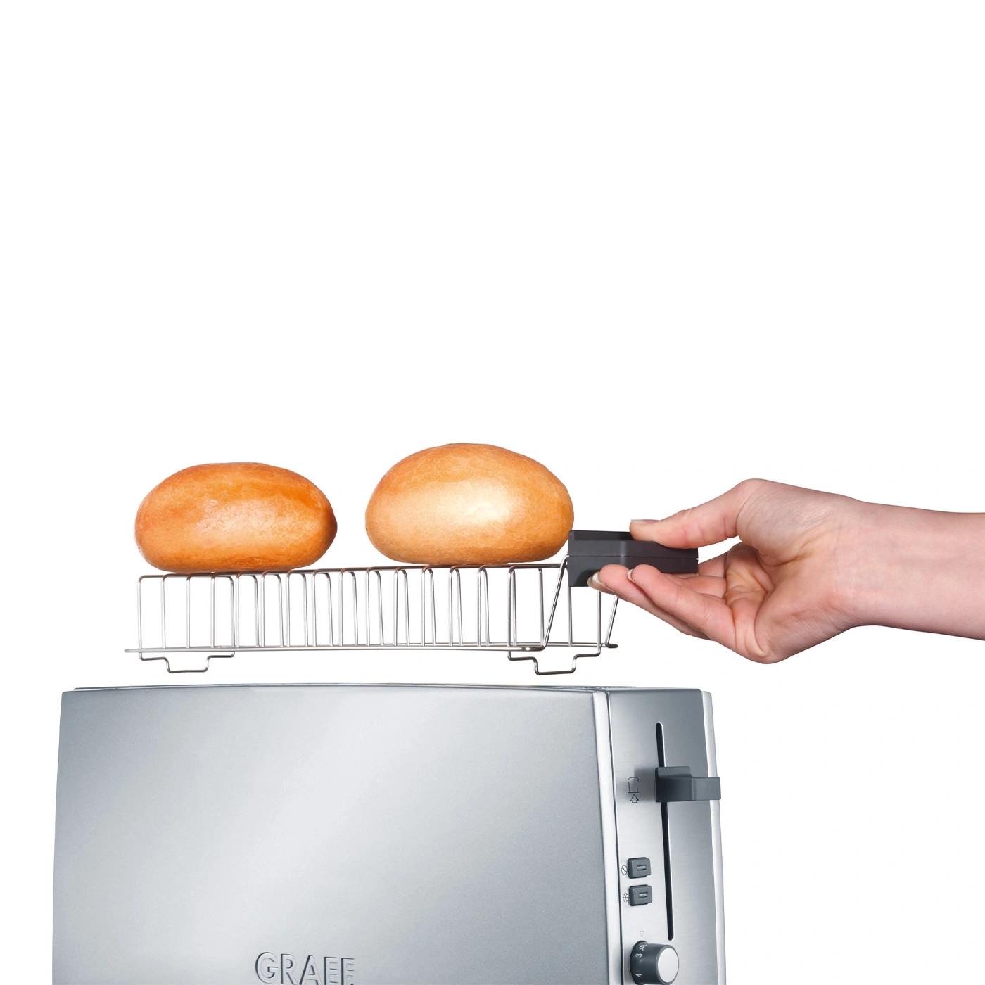Toaster with bun attachment and two buns being held by a hand, ready to toast.