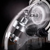 Close-up of a transparent device with gears and a motor, detailed view