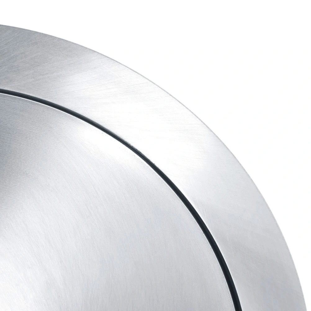 Close-up of a silver, circular metal plate with a black line, shiny surface.