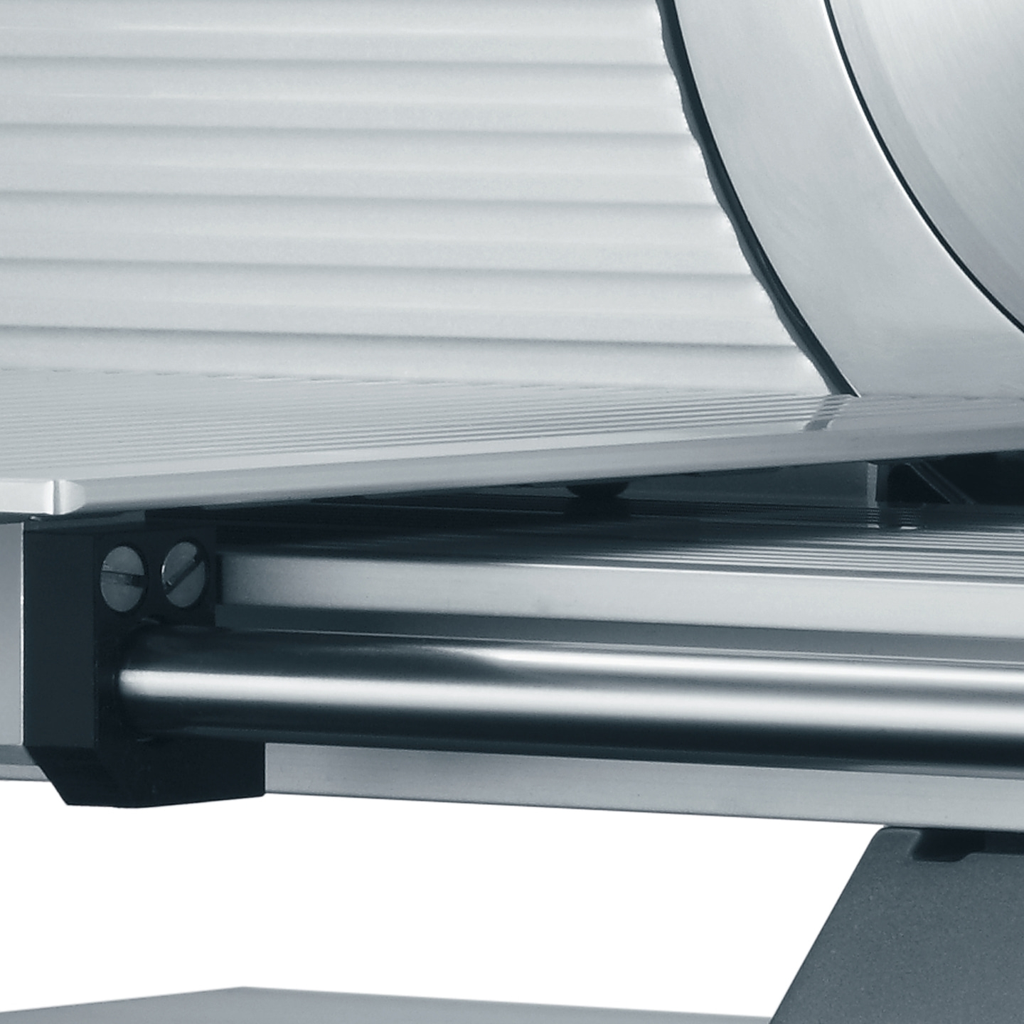 Close-up of a meat slicer, blade, and detailed metallic parts.