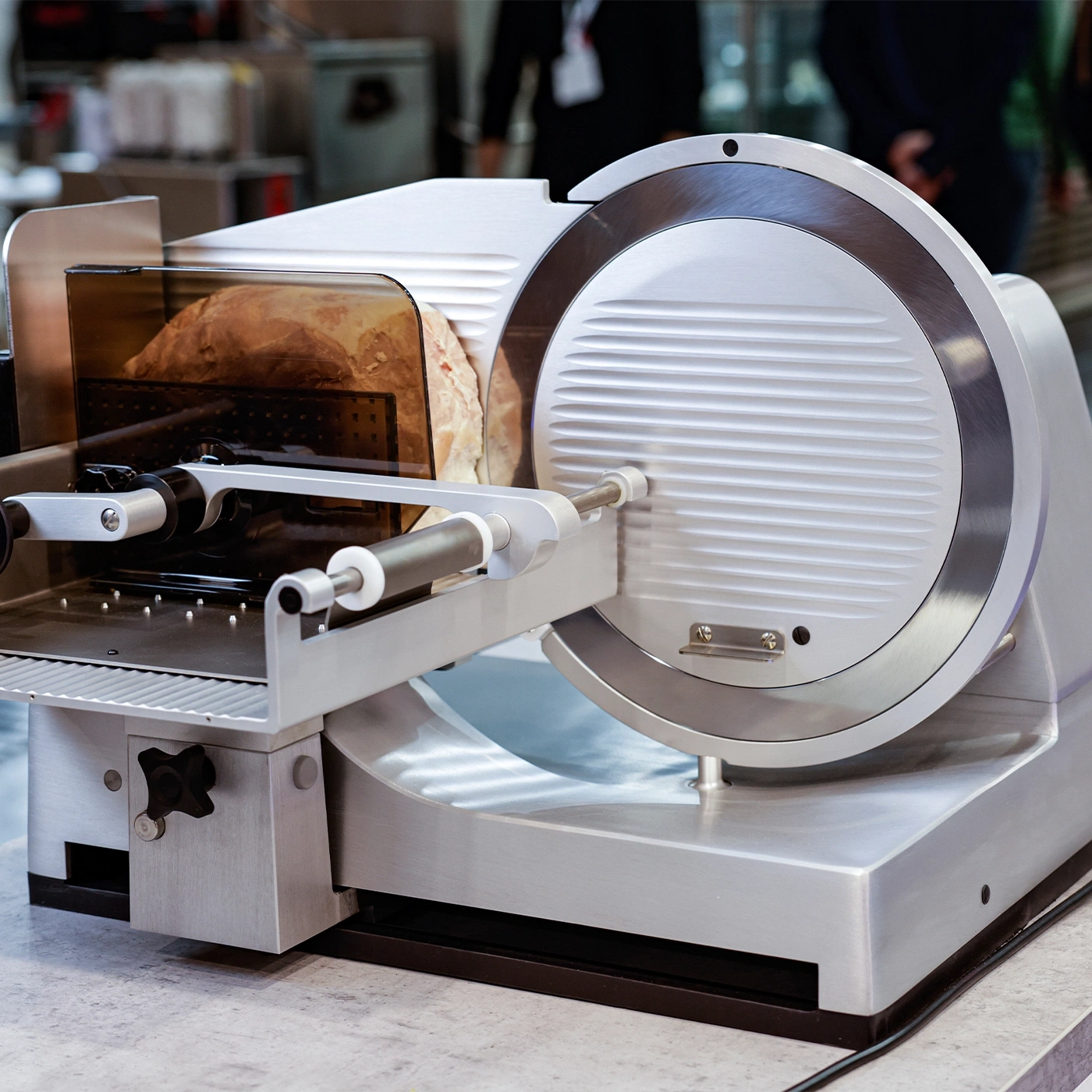 Meat slicer with bread. Stainless steel, professional, kitchen, food preparation.