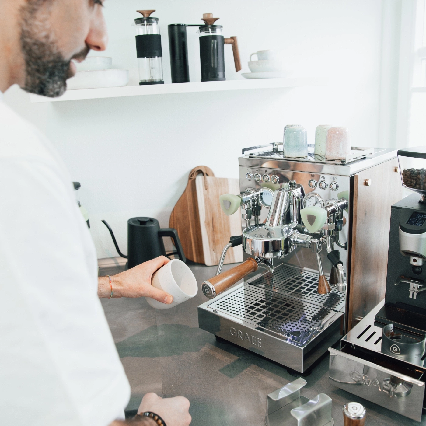 Man preparing coffee with espresso machine, kitchen, Graef machine, cup