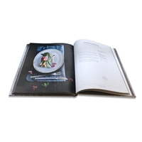 Cookbook with spring onion recipe and plate with food on it