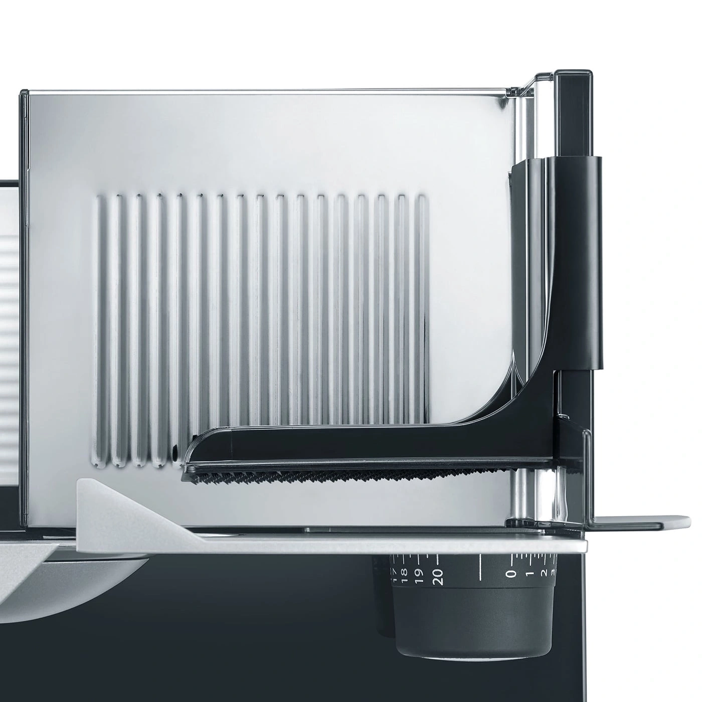 Close-up of a silver and black meat slicer with scale and blade detail