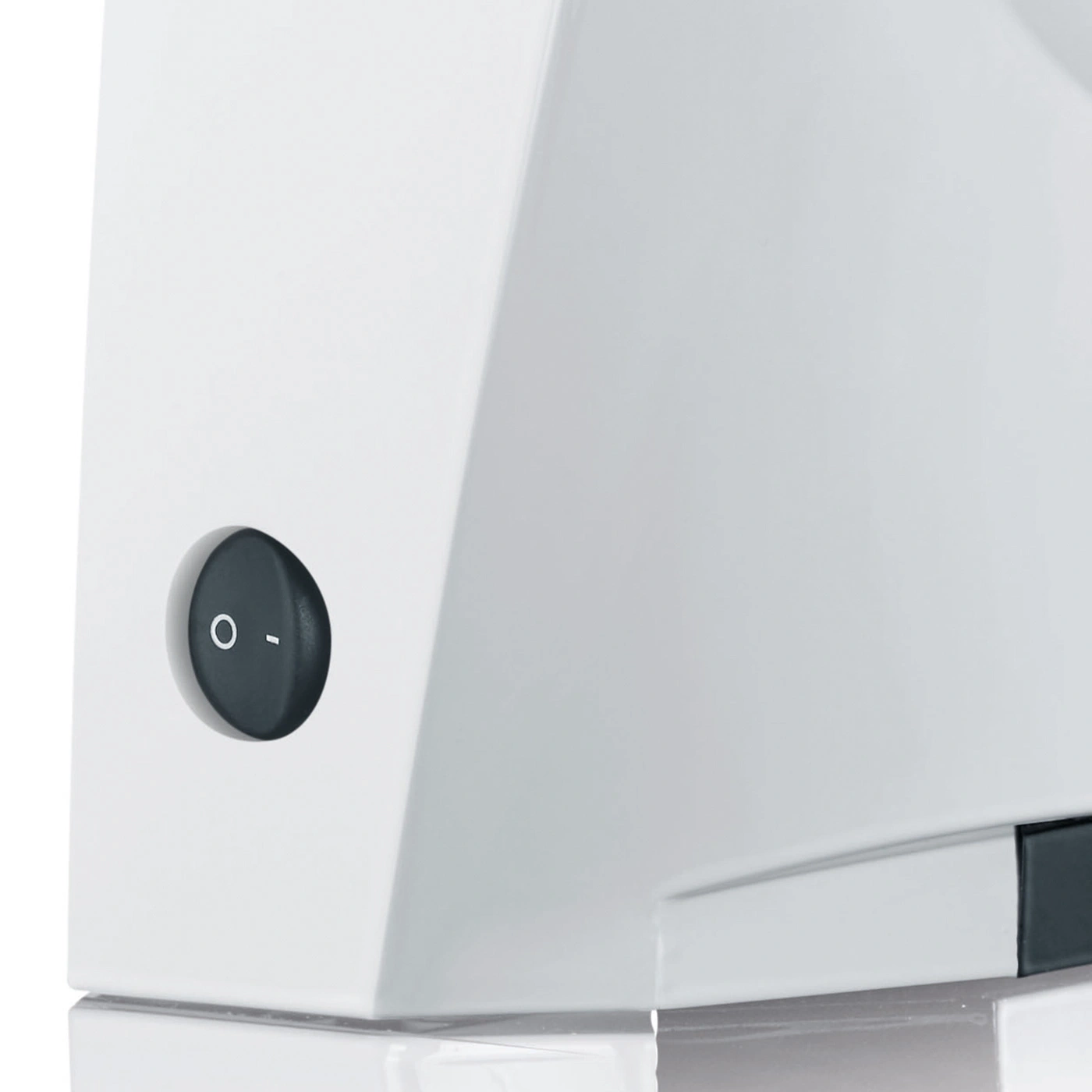 Close-up of a white appliance with a black rocker switch in the off position.