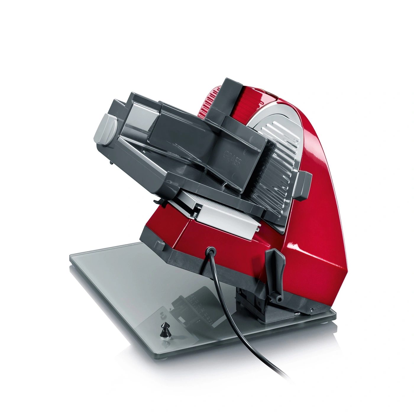Red electric slicer with glass plate and cable, isolated on white background
