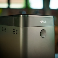 Graef appliance, gray, with logo and button, close-up, detail shot, device
